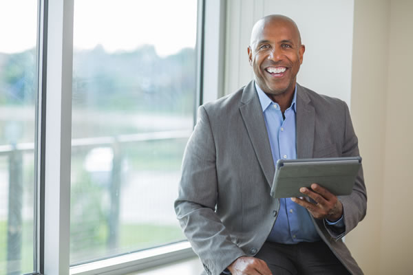 man posed in front of a window