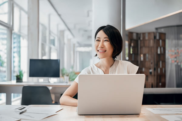 woman thinking in front of computer